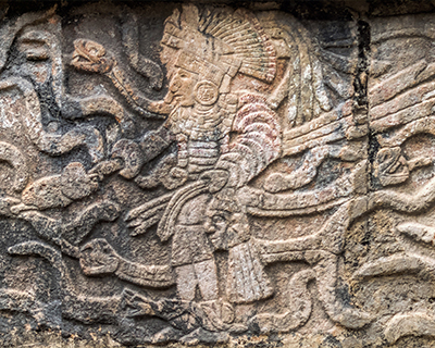 mexico chichen itza warrior holding a head relief